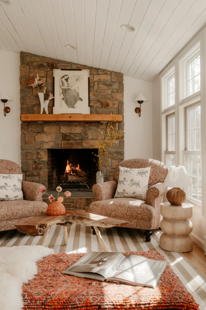 Living room with a stone fireplace and armchairs