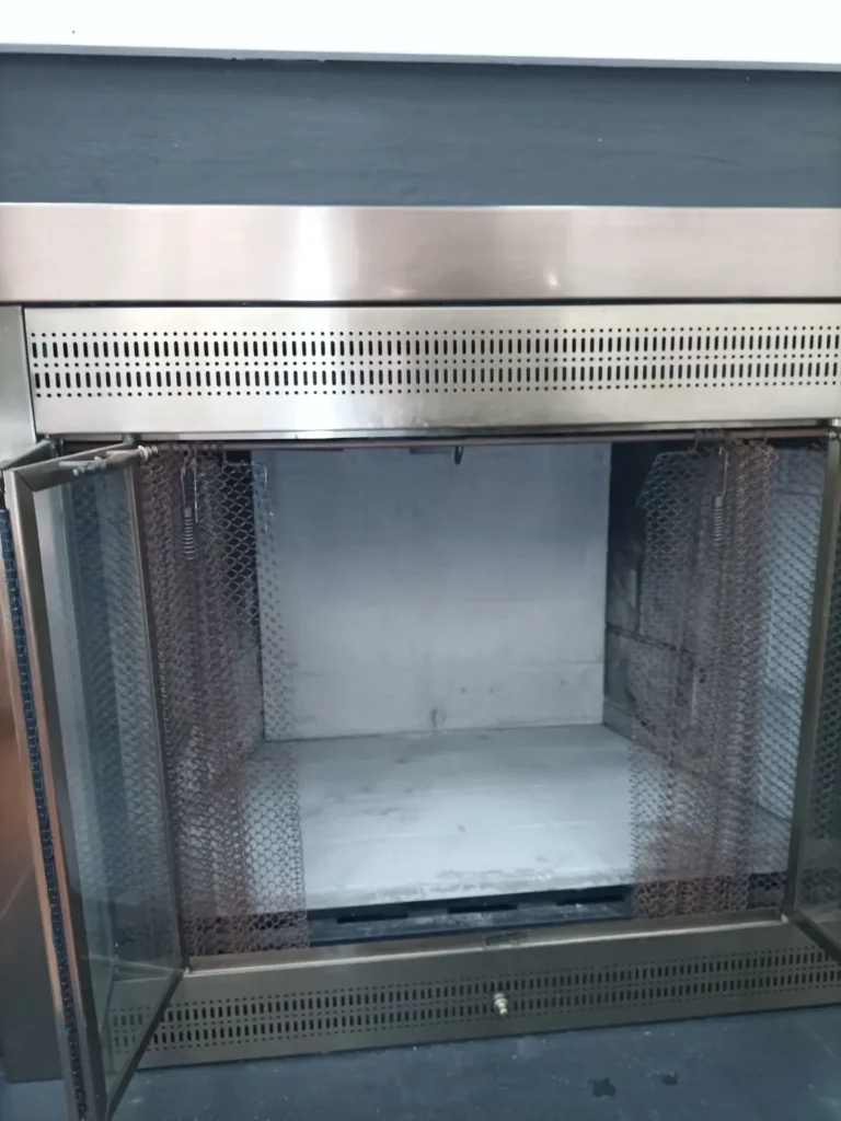 Fireplace interior panels and open glass doors at a Burlington home