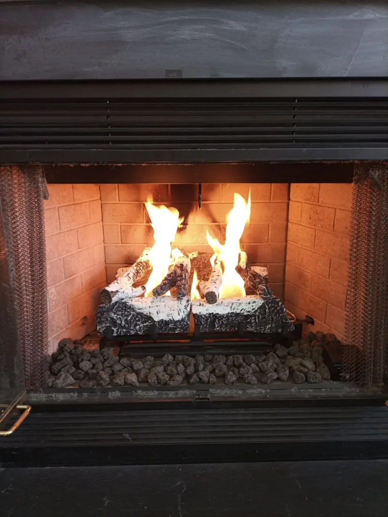Gas log fireplace with visible flames in Winslow Township