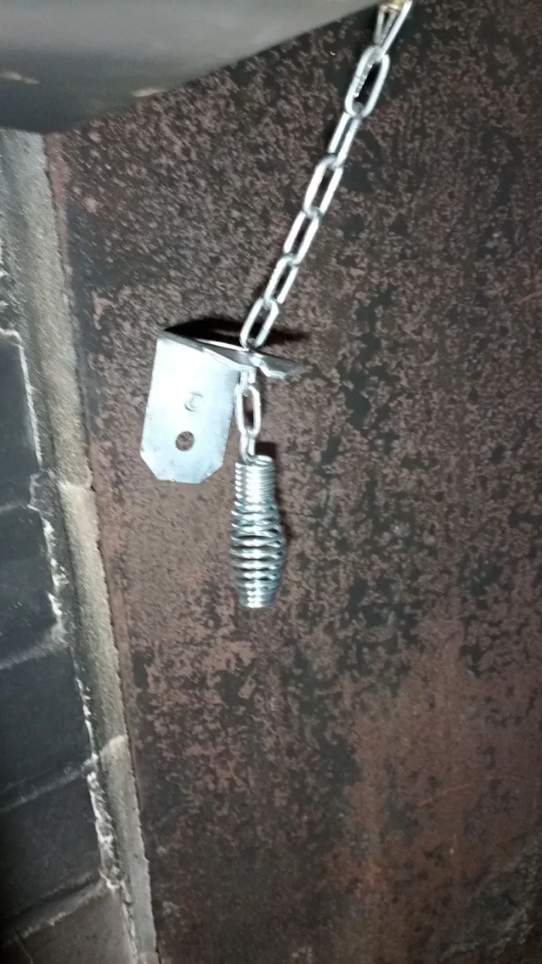 Cap damper chain and spring handle inside a Gloucester City fireplace