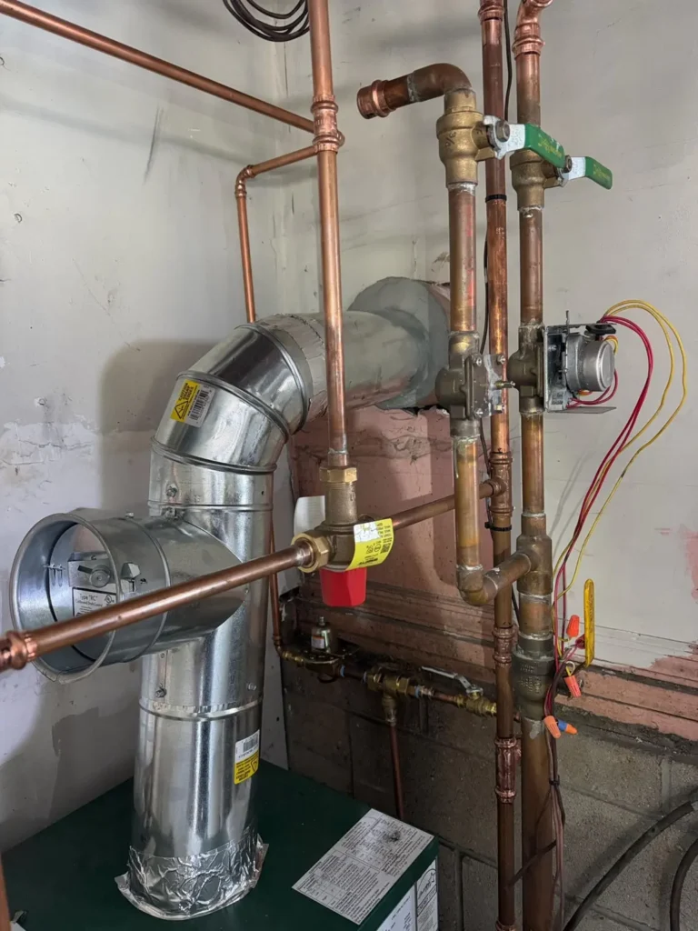 Heating vent connection and surrounding pipework in Sussex