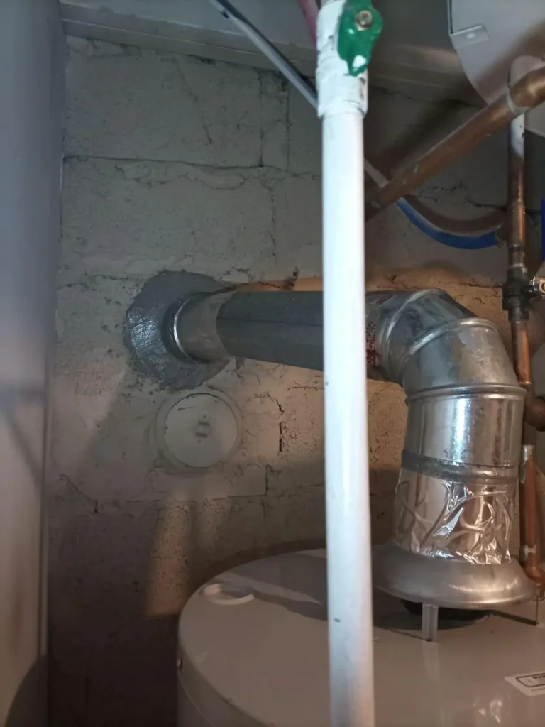 Interior heating vent connection entering the chimney wall in Wayne