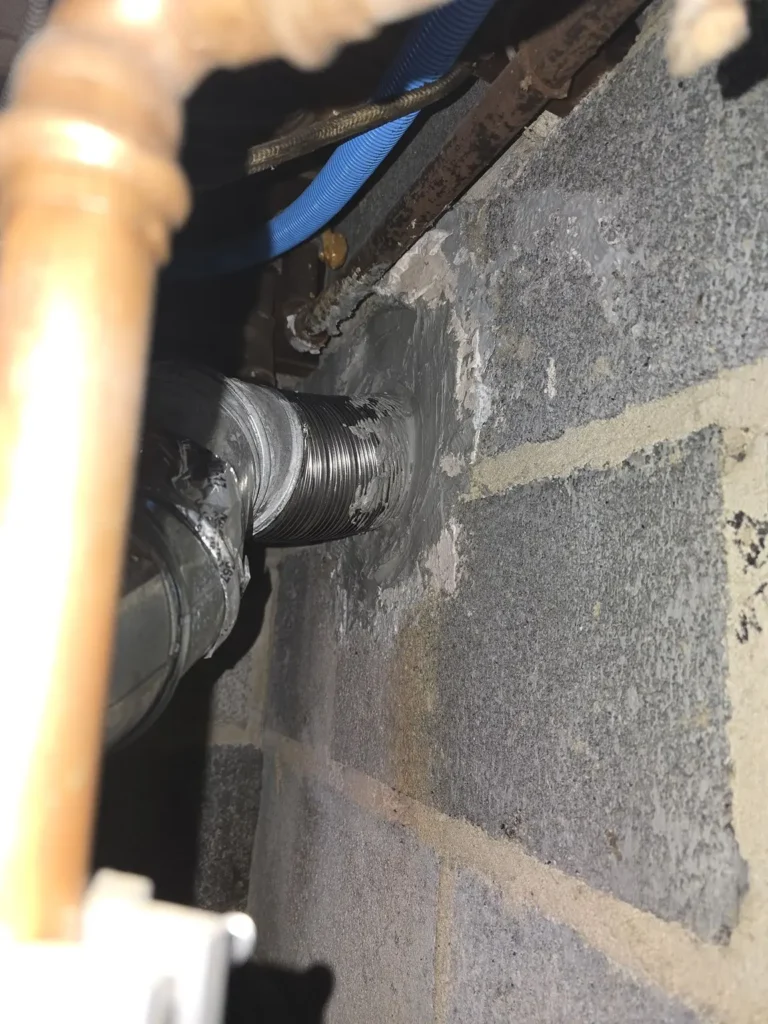 Vent connection entering the chimney wall at a Fieldsboro home