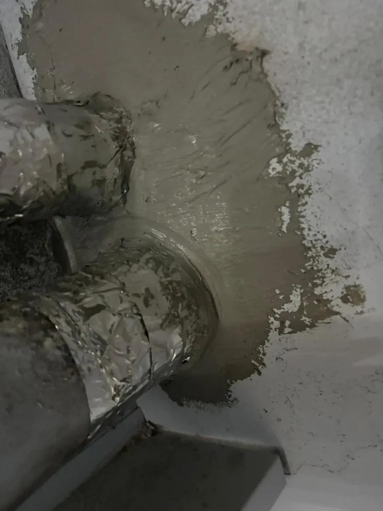 Close view of vent connections entering a chimney wall in Gloucester Township