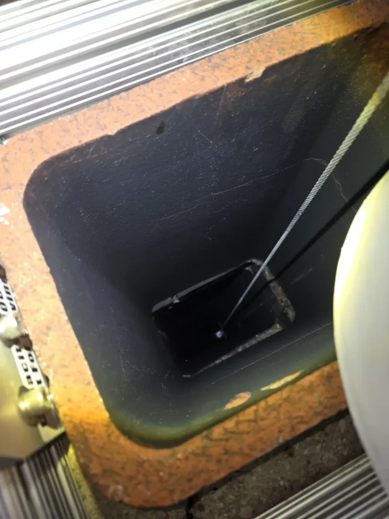 Damper operating cable visible inside the fireplace flue