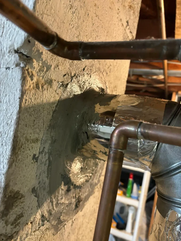 Close view of the chimney vent connection and wall penetration in Roxbury Township