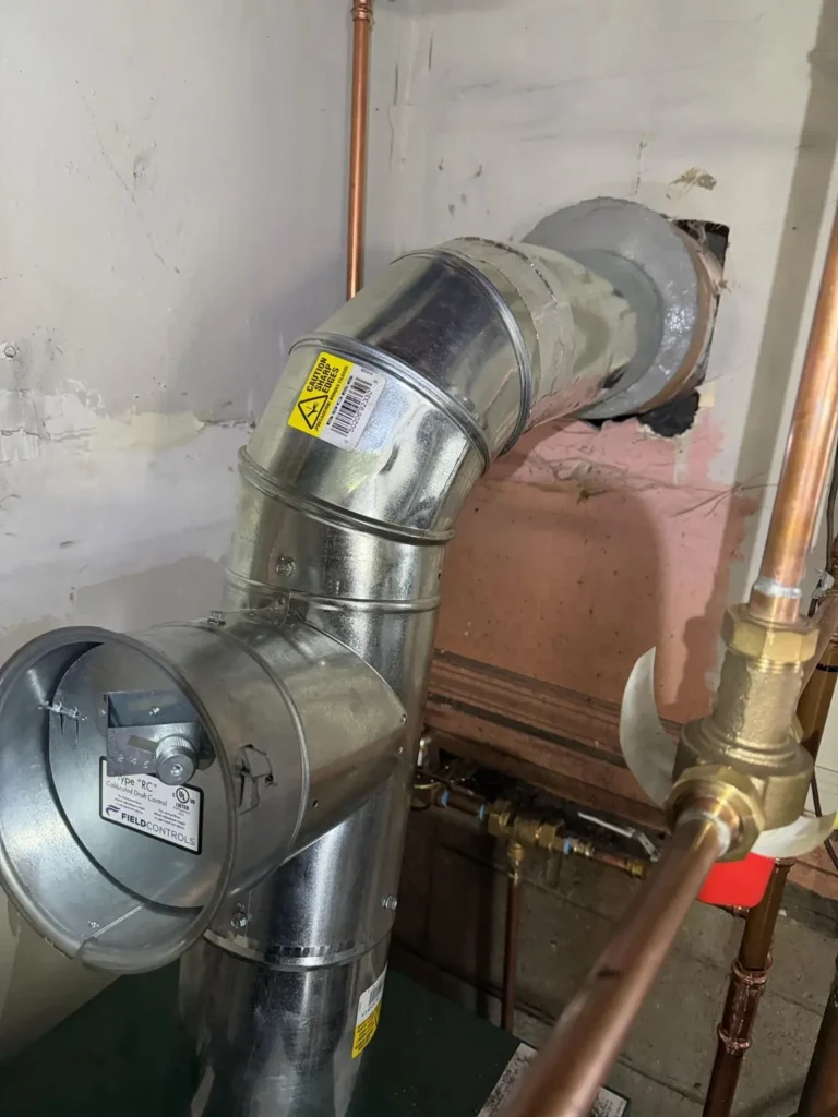Interior heating vent and chimney wall connection in Sussex