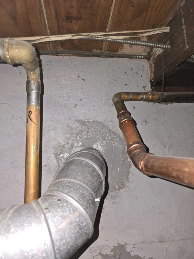 Heating vent pipe entering the chimney wall in Milltown