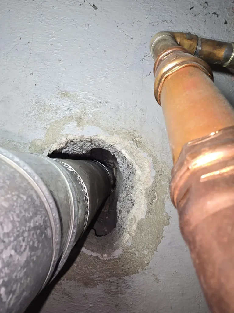 Detail of the heating vent pipe at the chimney wall opening